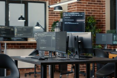 computer-screens-running-programming-code-empty-software-developing-agency-office-computers-parsing-data-algorithms-background-neural-network-servers-cloud-computing-data-room